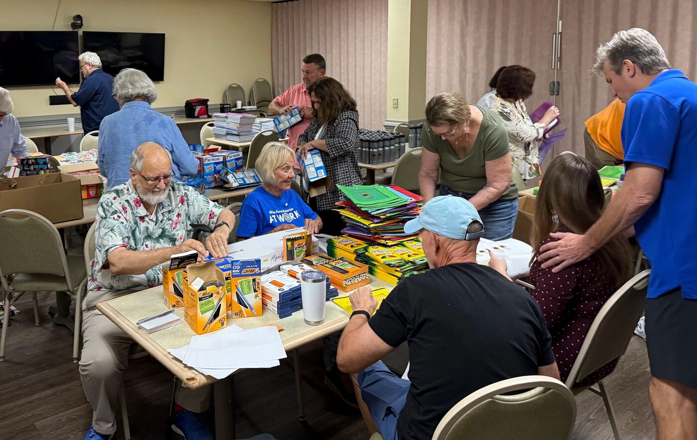 Wake Forest Rotary members packing school supplies at a service project